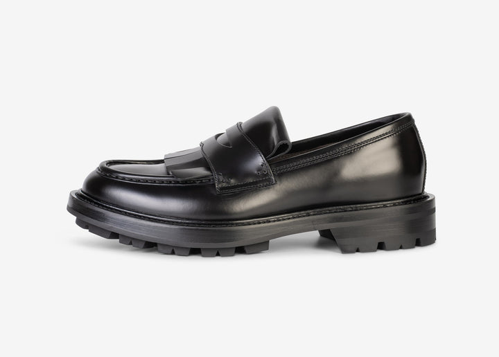 Black loafer with fringe tab