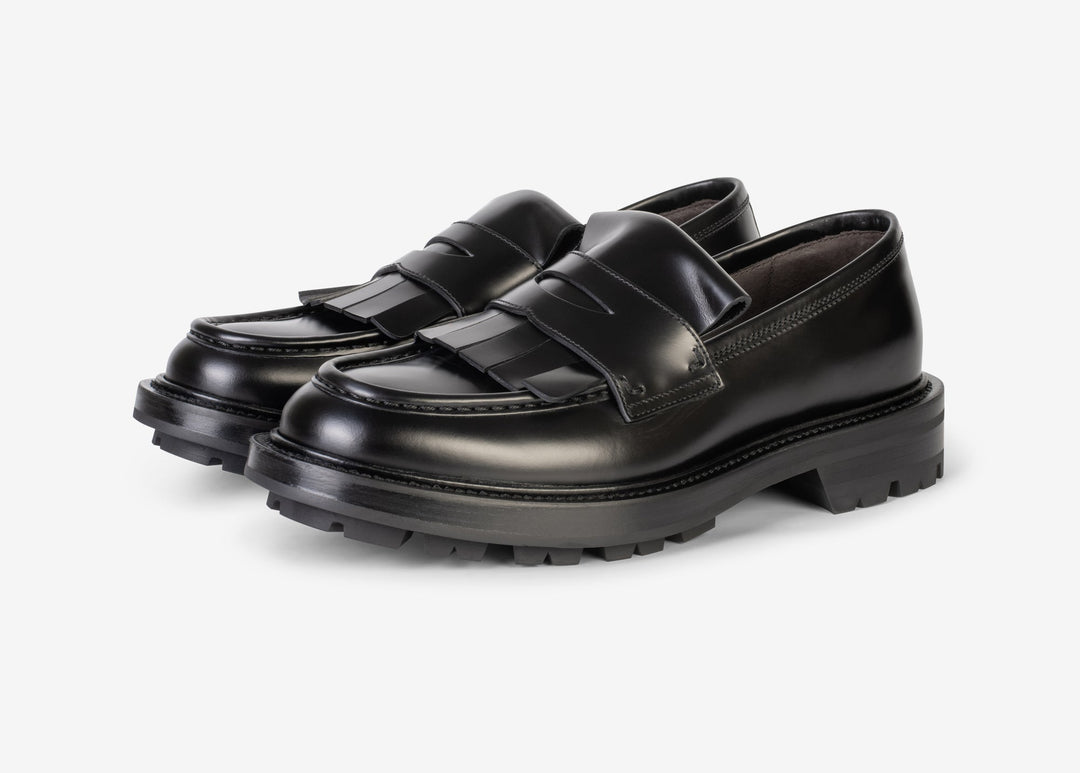 Black loafer with fringe tab