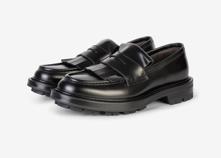 Black loafer with fringe tab