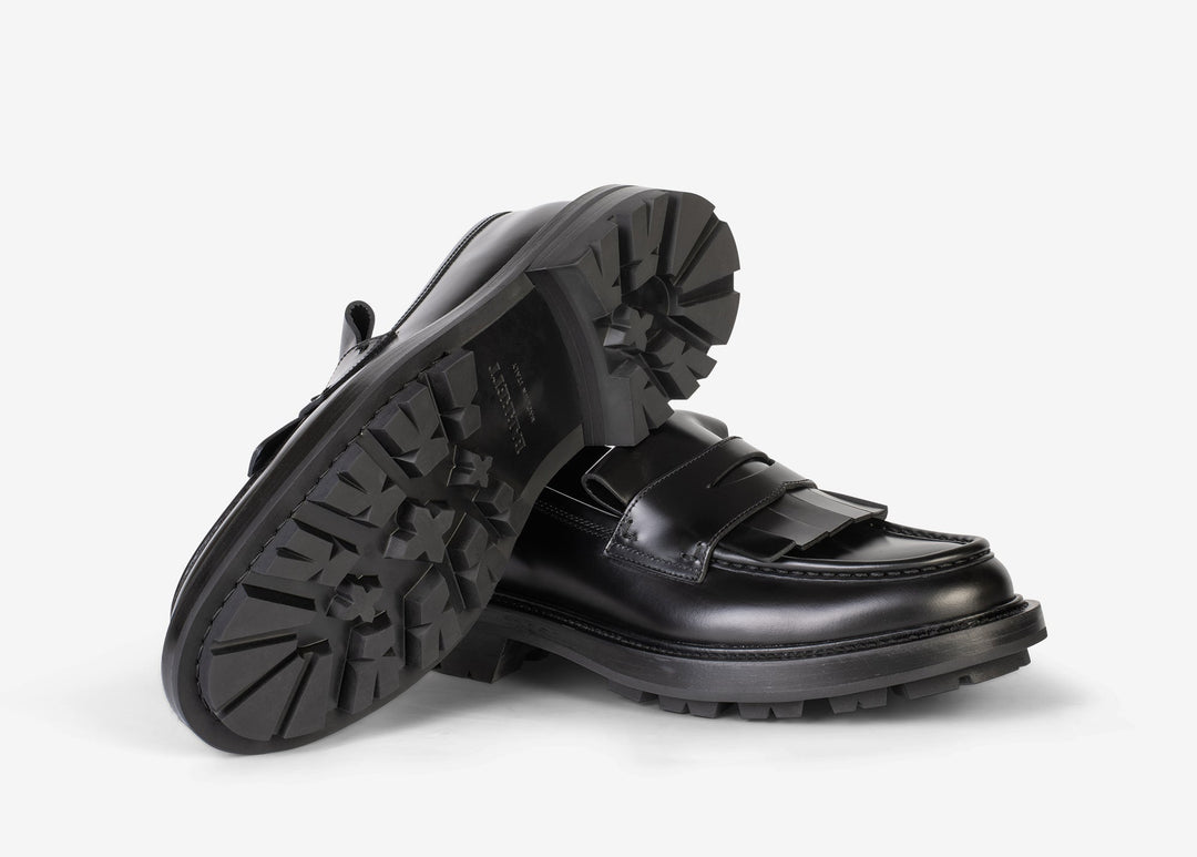 Black loafer with fringe tab