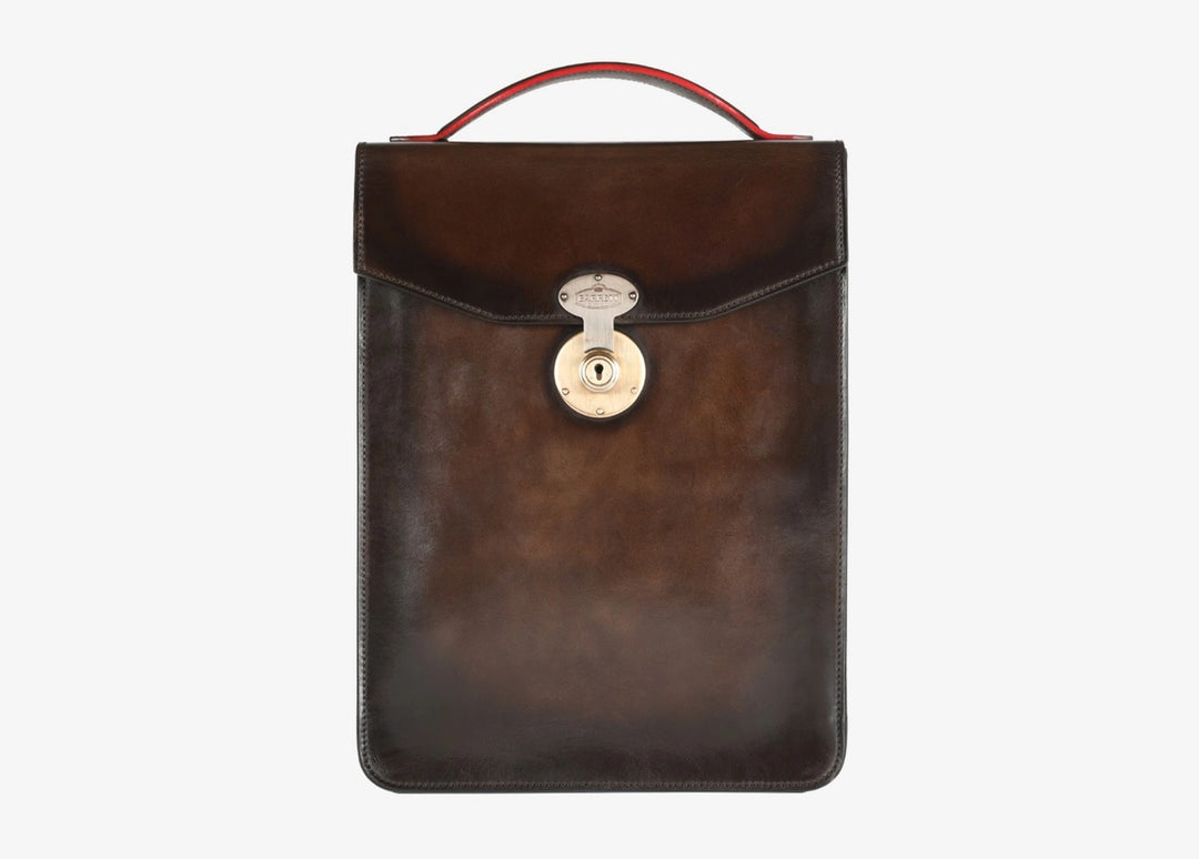 Hand-aged bag with snap fastening